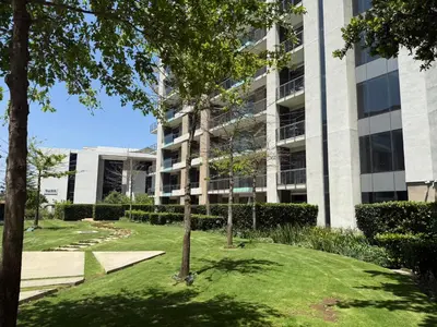 an apartment building with a lawn in front of a building at 136 Trilogy in Pretoria