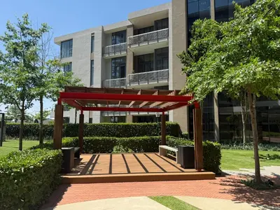 a red pavilion in front of a building at 136 Trilogy in Pretoria