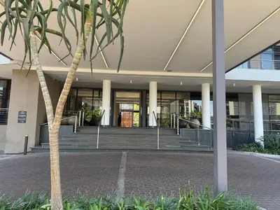 a building with a palm tree in front of it at 136 Trilogy in Pretoria