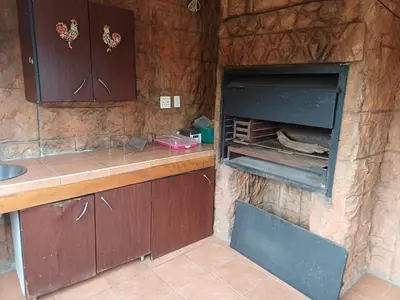 a kitchen with a counter and an open oven at Bufflesdrift Bush and Birding in Pretoria