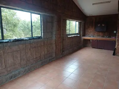 an empty room with windows and a tiled floor at Bufflesdrift Bush and Birding in Pretoria