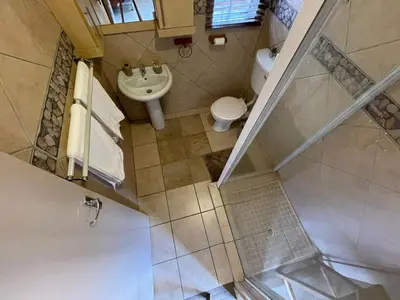 an overhead view of a bathroom with a toilet and sink at Bet Baruch Accommodation 1 in Polokwane