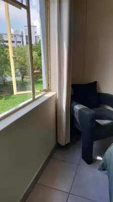 a room with a window and a chair and a window at La Boheme in Pretoria