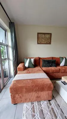 a living room with a couch and a couch at La Boheme in Pretoria