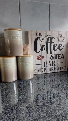 a group of cups sitting on a counter next to a sign at La Boheme in Pretoria