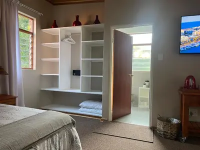 a bedroom with a door open to a room at B&B on the Sabie in Sabie