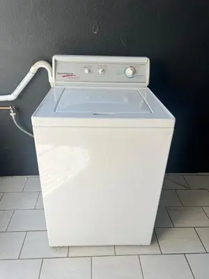a white refrigerator sitting on top of a tile floor at 326onMackenzieSt in Pretoria