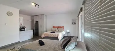 a small bedroom with a bed and a kitchen at Tenuta Overnight Suite in Polokwane