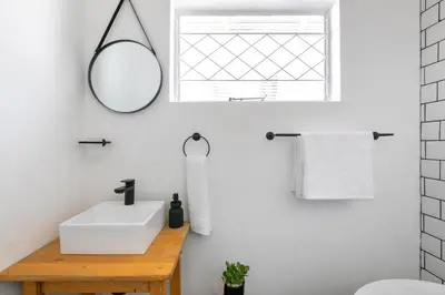 a bathroom with a sink and a mirror at Maroelana Home in Pretoria