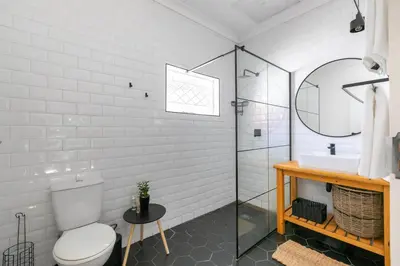 a bathroom with a toilet and a sink and a mirror at Maroelana Home in Pretoria