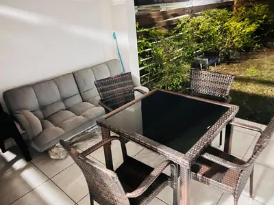 a patio with a table and chairs and a couch at The Blyde Crystal Lagoon in Pretoria