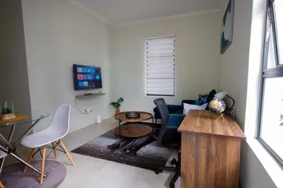 a living room with a table and a couch at PC Luxe Stays exquisite apartments in Erand