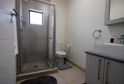 a bathroom with a shower and a toilet and a sink at PC Luxe Stays exquisite apartments in Erand
