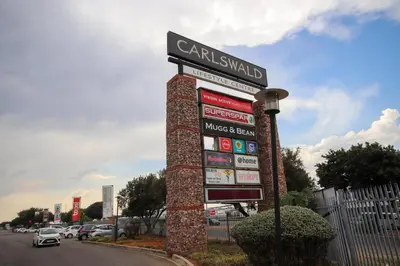 a sign for a car dealership on the side of a road at PC Luxe Stays exquisite apartments in Erand