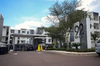 a parking lot in front of a white building at PC Luxe Stays exquisite apartments in Erand