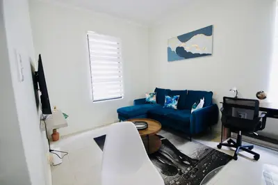 a living room with a blue couch and a tv at PC Luxe Stays exquisite apartments in Erand