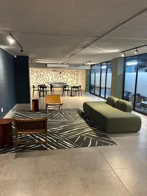 a living room with a couch and chairs and tables at Circa apartment hotel in Pretoria