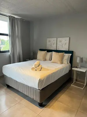 a bed with two towels on it in a bedroom at Circa apartment hotel in Pretoria