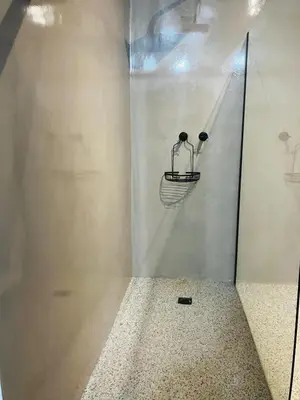 a glass wall with a chair in a room at Moonlight in Marloth Park