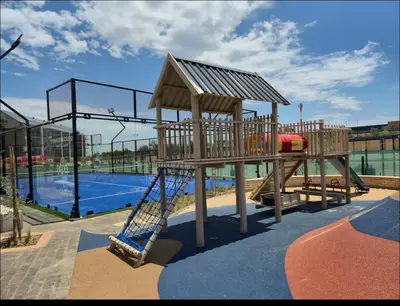 a wooden playground with a slide at The Aura at Castle Gate in Pretoria
