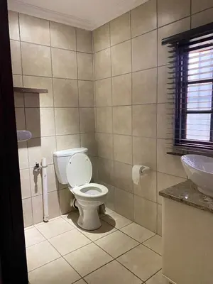 a bathroom with a toilet and a sink at The N1 Farm Place in Pretoria