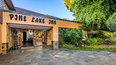 a store with a sign that reads pine cake shop at African Sky Hotels - Pine Lake Inn in White River