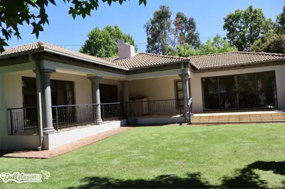 a house with a lawn in front of it at Central Park in Dullstroom