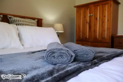 a pair of towels sitting on top of a bed at Central Park in Dullstroom