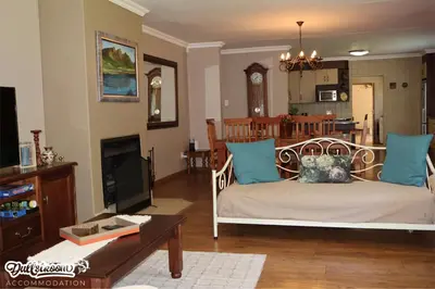a living room with a couch and a table at Central Park in Dullstroom