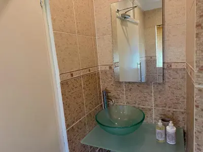 a bathroom with a green bowl sink on a counter at 06 Enkeldoring in Pretoria
