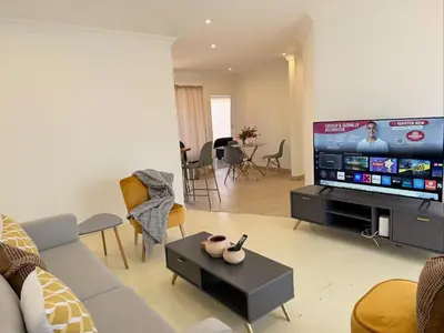 a living room with a large flat screen tv at 06 Enkeldoring in Pretoria