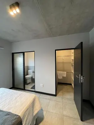 a bedroom with a bed and a bathroom with a toilet at Midrand Dream Staycation in Midrand