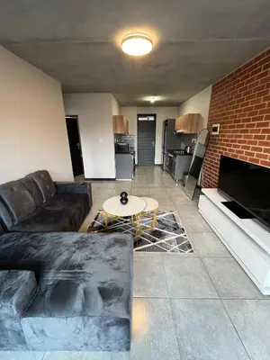 a living room with a couch and a table at Midrand Dream Staycation in Midrand