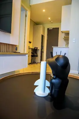 a black chair sitting on a table in a room at Menlyn Maine luxury apartments in Pretoria