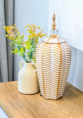 a table with a vase of flowers and a lamp at Menlyn Maine luxury apartments in Pretoria