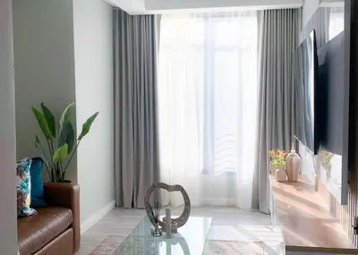 a living room with a couch and a glass table at Menlyn Maine luxury apartments in Pretoria