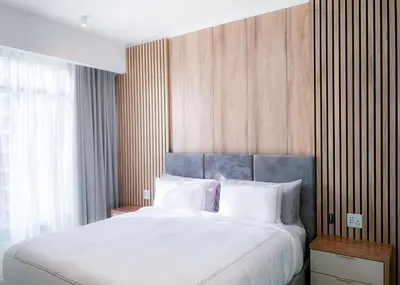 a bedroom with a large bed with white pillows at Menlyn Maine luxury apartments in Pretoria