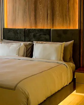 a large bed with white pillows in a bedroom at Menlyn Maine luxury apartments in Pretoria