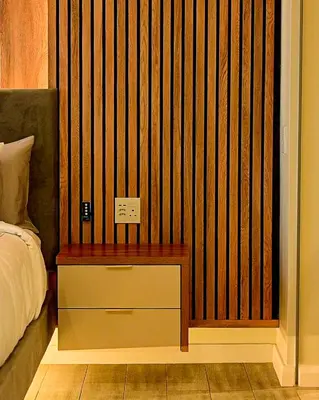 a bedroom with a bed and a wooden wall at Menlyn Maine luxury apartments in Pretoria