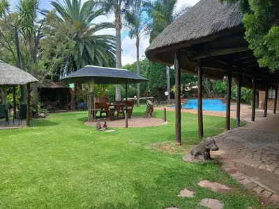 a resort yard with statues of animals in the grass at Aero Garden Ensuite in Johannesburg