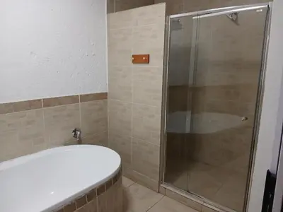 a bathroom with a shower and a toilet at Aero Garden Ensuite in Johannesburg