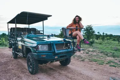a woman sitting on the back of a green jeep at Honeyguide Tented Safari Camp - Khoka Moya in Manyeleti Game Reserve