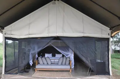 a canvas tent with a bed in it at Honeyguide Tented Safari Camp - Khoka Moya in Manyeleti Game Reserve