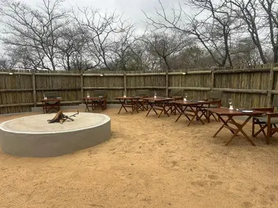 a group of picnic tables and tables with a monkey on it at Cheetah Paw Safari Lodge in Guernsey Nature Reserve