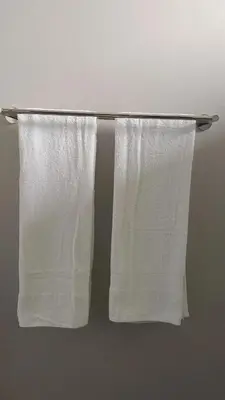 two white towels are hanging on a towel rack at The Eyrie in Nelspruit