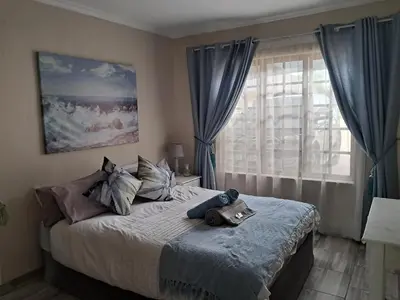 a bedroom with a bed and a window at Sunflower Stables Cottage in the Garden in Midrand