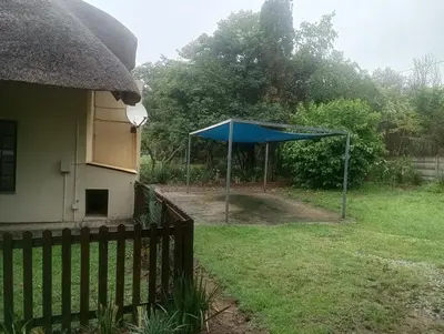 a blue tent in a yard next to a house at Sunflower Stables Cottage in the Garden in Midrand