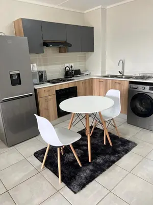 a kitchen with a white table and two chairs at East Luxe BNB 2bed 2bath in Pretoria