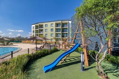 a playground with a slide in front of a building at East Luxe BNB 2bed 2bath in Pretoria