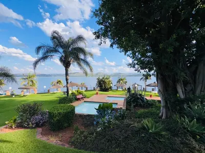 a resort with a swimming pool and palm trees at Olives by Agnes 31 in Hartbeespoort
